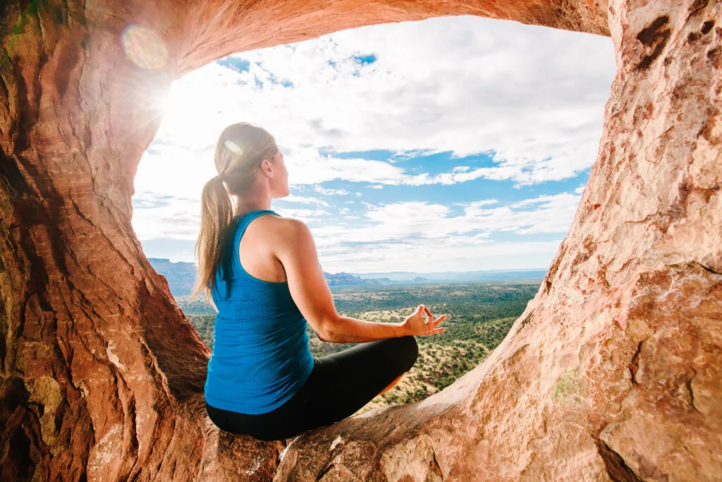 Person meditating peacefully in nature, practicing mindfulness